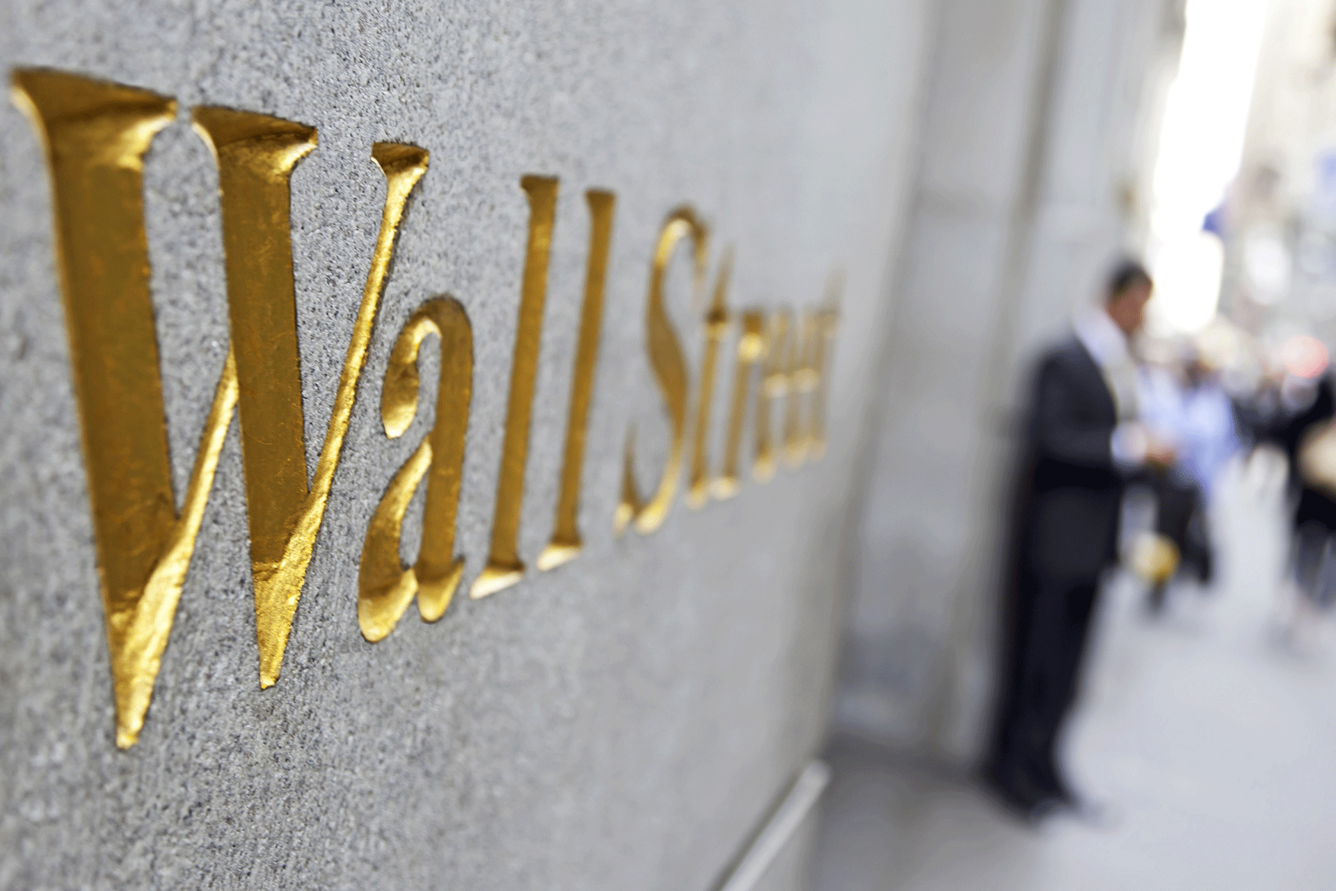 Side view of gold Wall Street sign