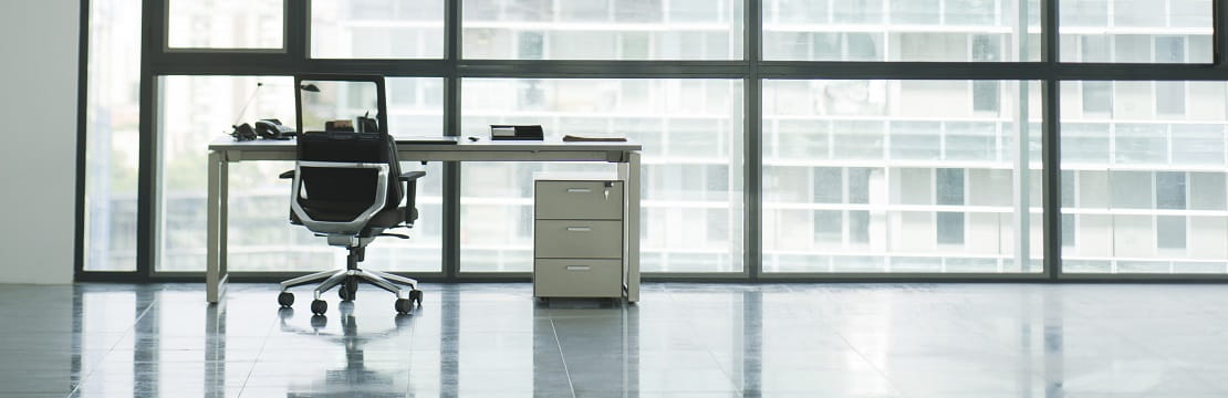 Empty chair and desk alone in an empty office. 