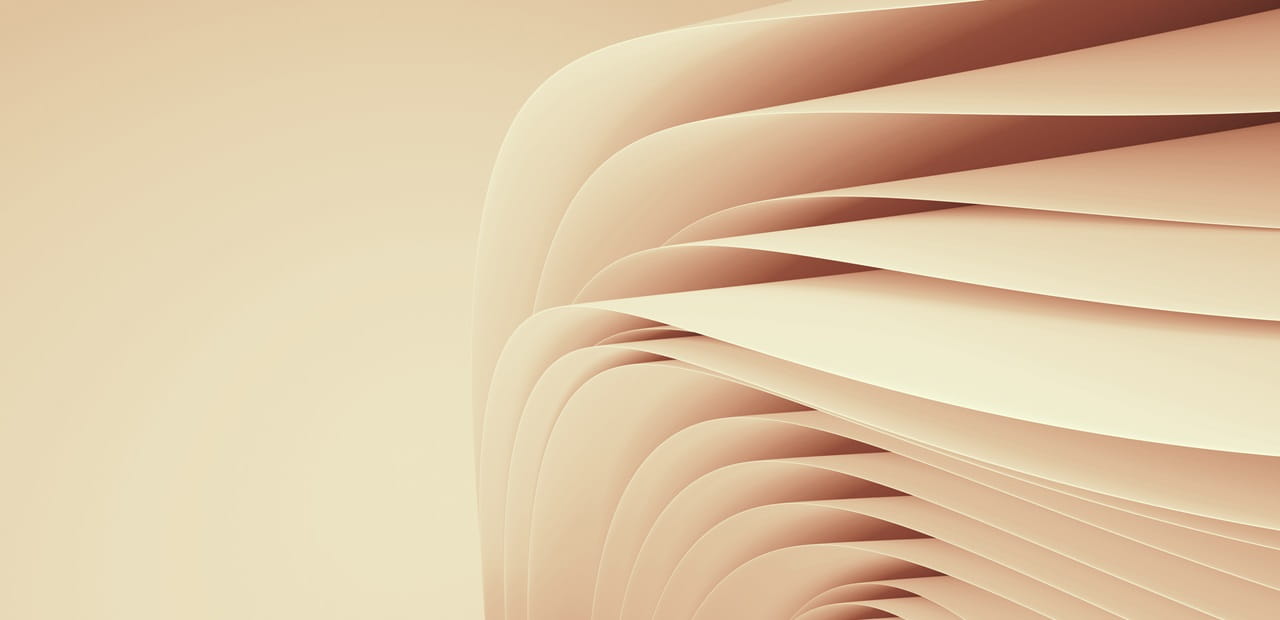The image shows a series of smooth, curved, beige layers or folds that create an abstract, flowing pattern.