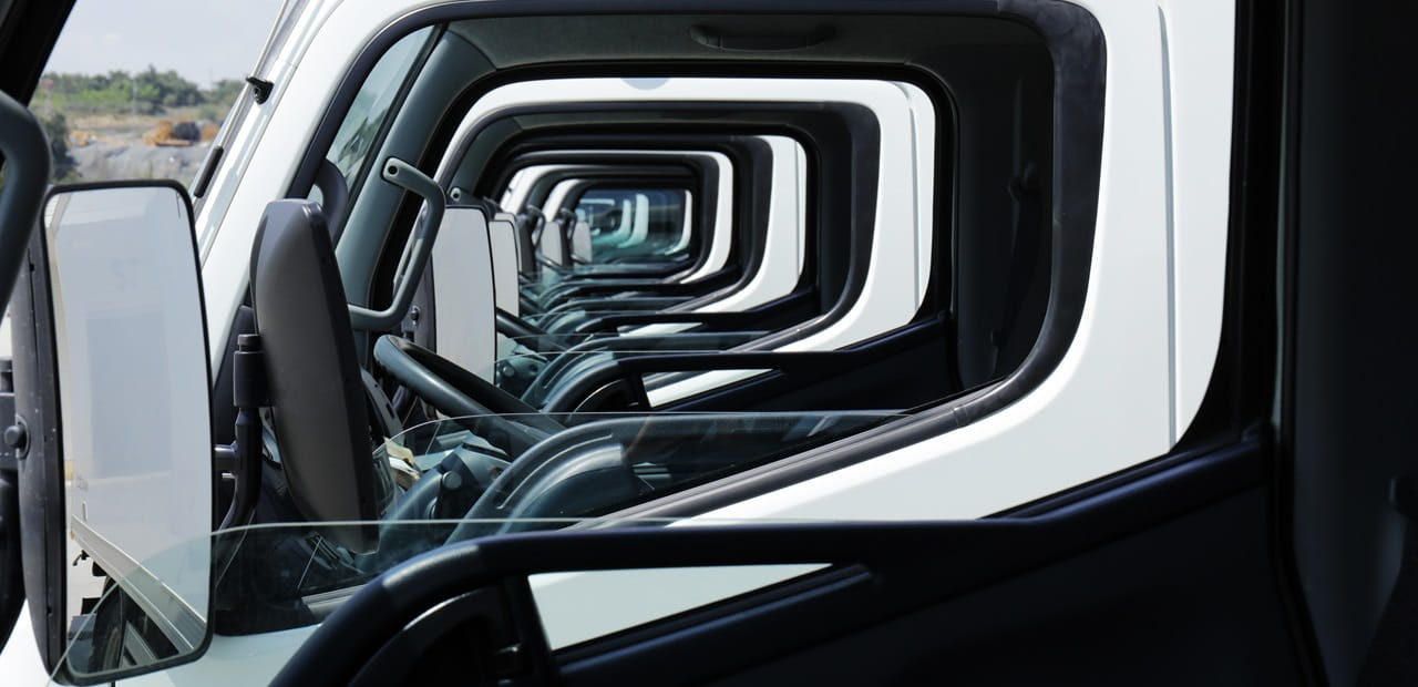 Stylish photo taken through the front driver-side window of a row of service vehicles