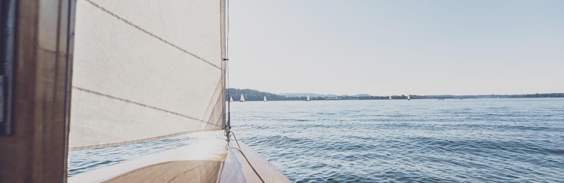  Sailboat on open water symbolizing generational contrast since generational experiences are reshaping markets and driving the cultural forces behind tomorrow’s financial landscape.
