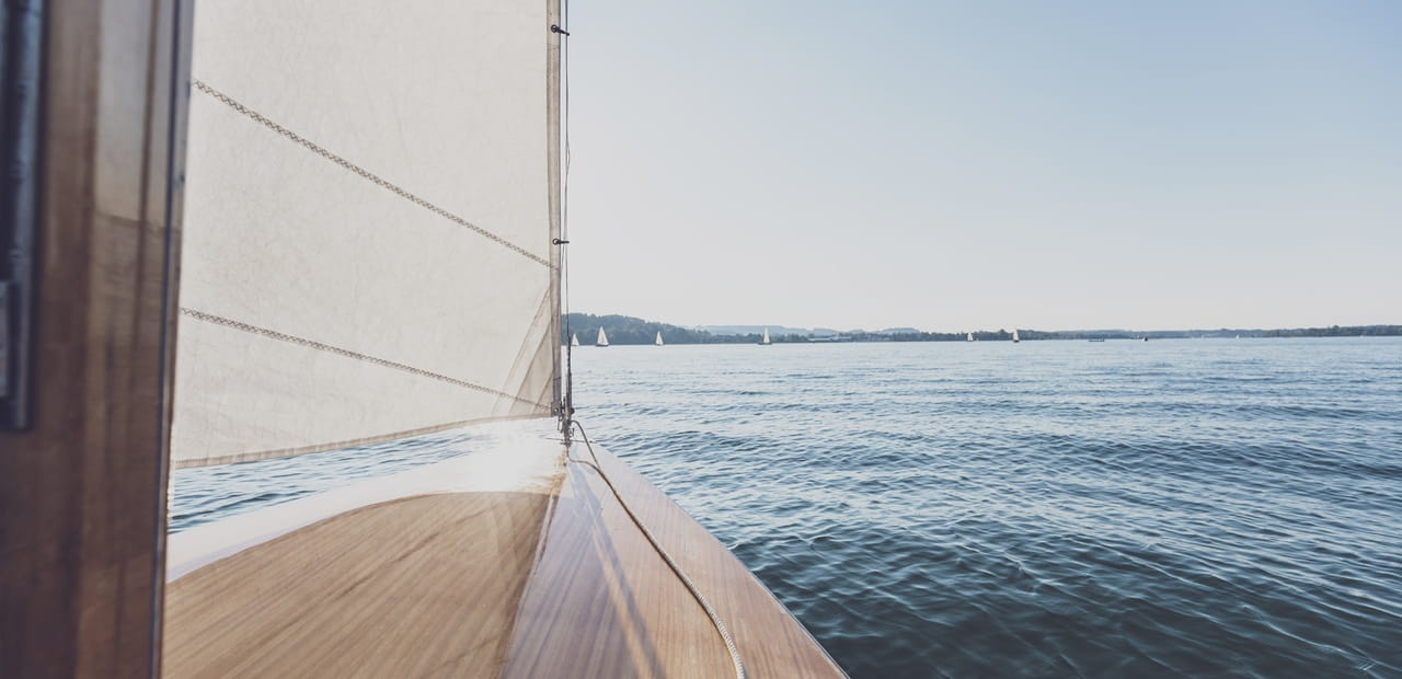  Sailboat on open water symbolizing generational contrast since generational experiences are reshaping markets and driving the cultural forces behind tomorrow’s financial landscape.