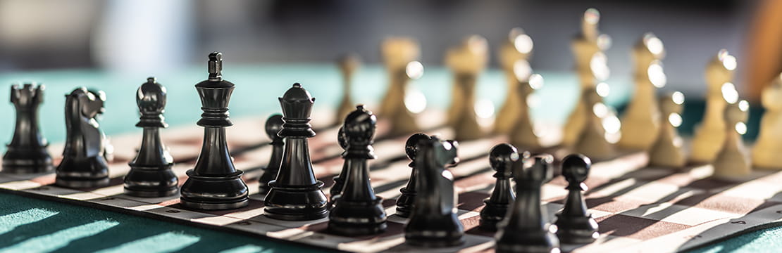 Chess pieces arranged strategically on a board, symbolizing smart planning and practical ways business owners can maximize their time.