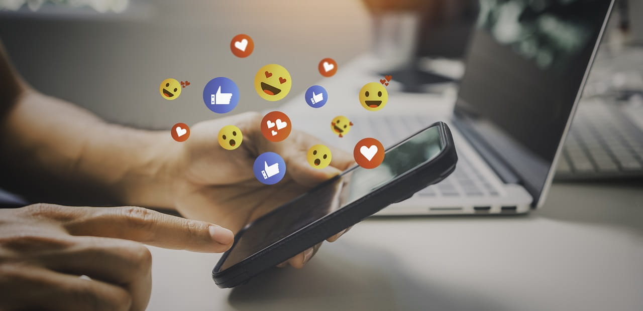 Man accessing social media platforms through his smart phone.