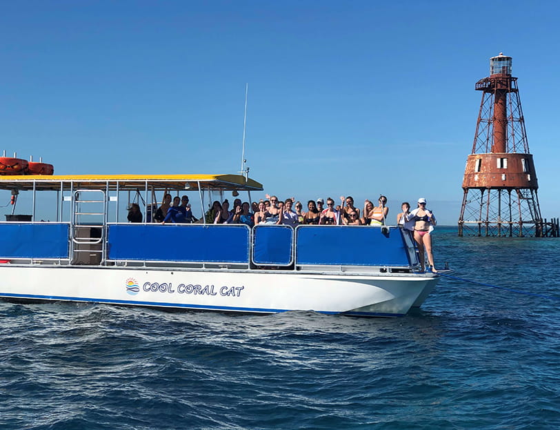 Ferry boat in open ocean with lighthouse